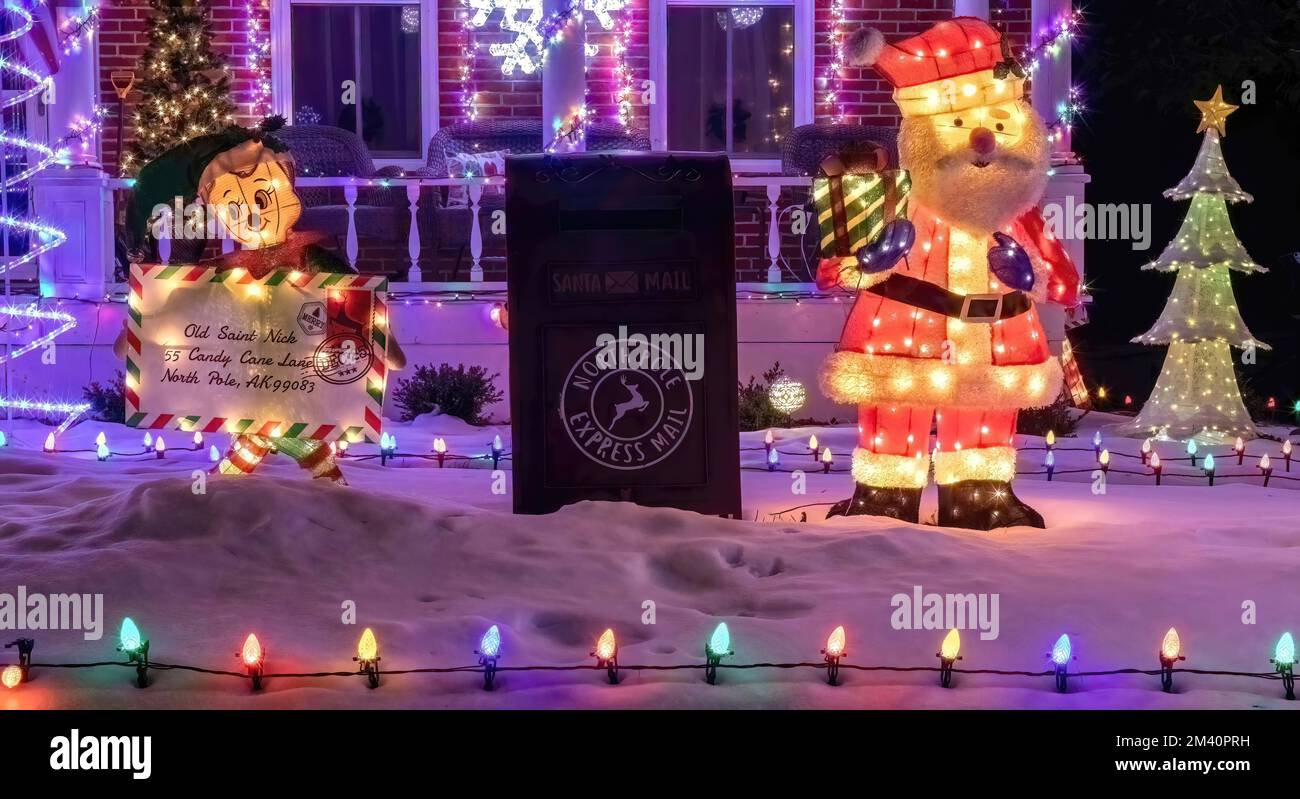 La cassetta postale di Babbo Natale per i bambini a inviargli lettere con Babbo Natale e il suo elfo tenendo una lettera in una serata invernale a San Croix Falls, Wisconsin, Stati Uniti. Foto Stock