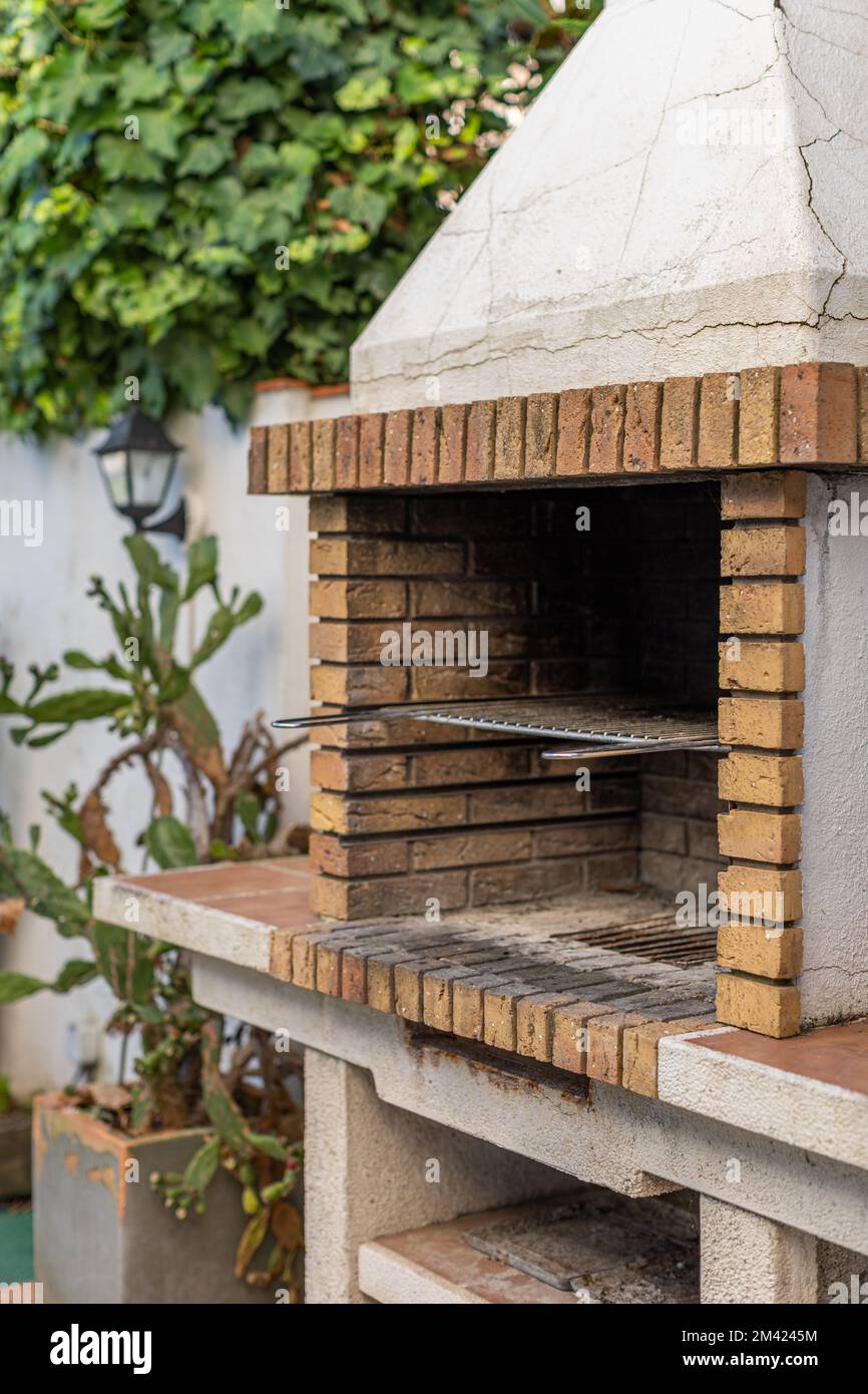 Barbecue griglia in mattoni gialli e cemento per cucinare piatti di carne e  verdure all'aperto nel cortile della casa. Cucinare cibo su un Foto stock -  Alamy