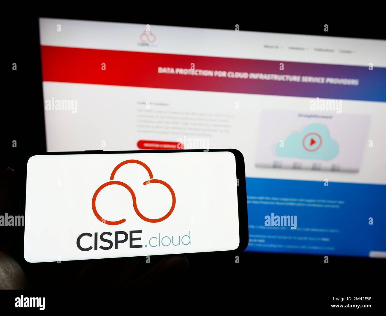 Persona che tiene il cellulare con il logo di provider di cloud associazione commerciale CISPE sullo schermo di fronte alla pagina web aziendale. Messa a fuoco sul display del telefono. Foto Stock