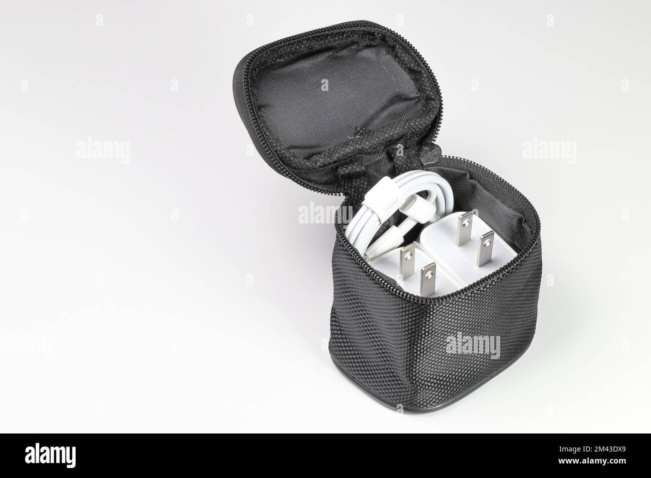 Adattatore caricabatterie bianco con cavo caricabatterie di tipo USB, nuovi accessori per caricabatterie in borsa da viaggio isolati su sfondo bianco. Foto Stock