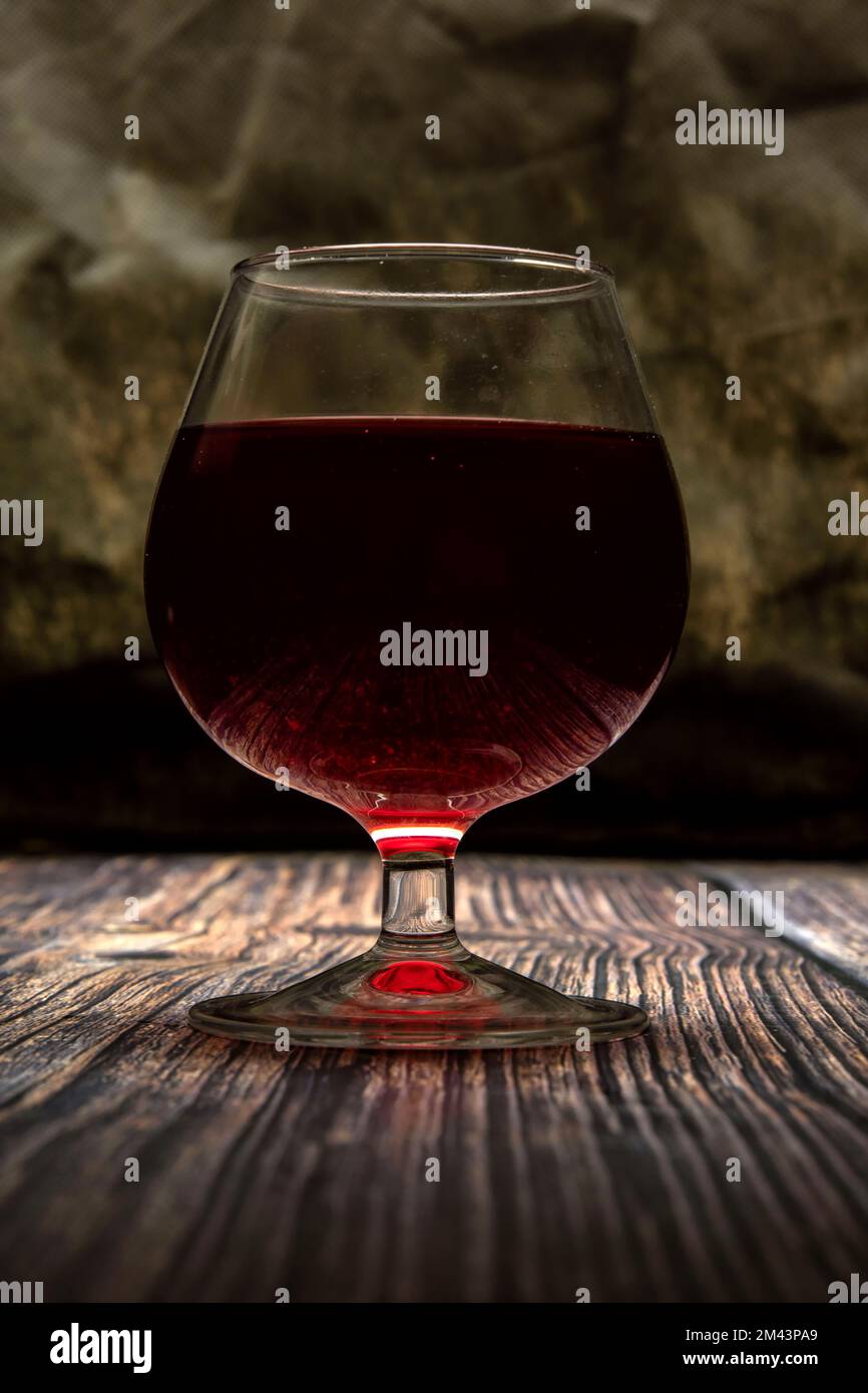Un bicchiere di vino rosso sul tavolo Foto Stock