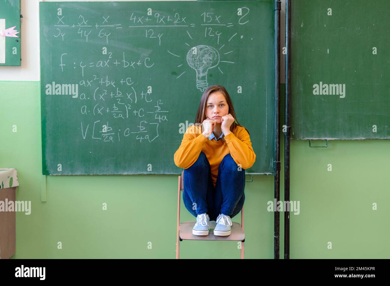 Ragazza adolescente in classe math sopraffatti dalla formula di per la matematica. Pressione, istruzione, concetto di successo. Foto Stock