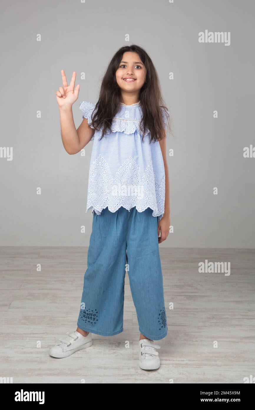Ritratto di una giovane ragazza araba che fa un segno a mano. Foto Stock