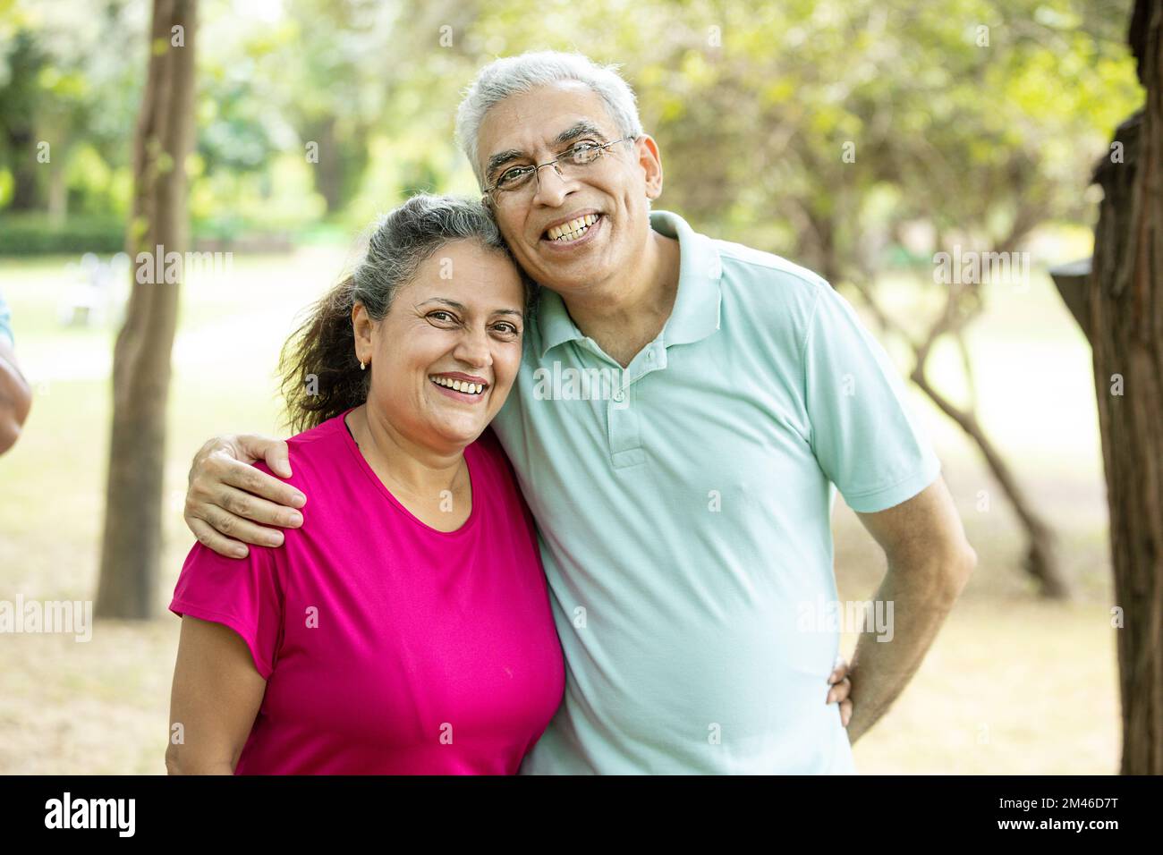 Ritratto di coppia anziana indiana felice al parco estivo. Vecchio uomo asiatico e donna in piedi all'aperto sorridente. vita di pensionamento, Foto Stock