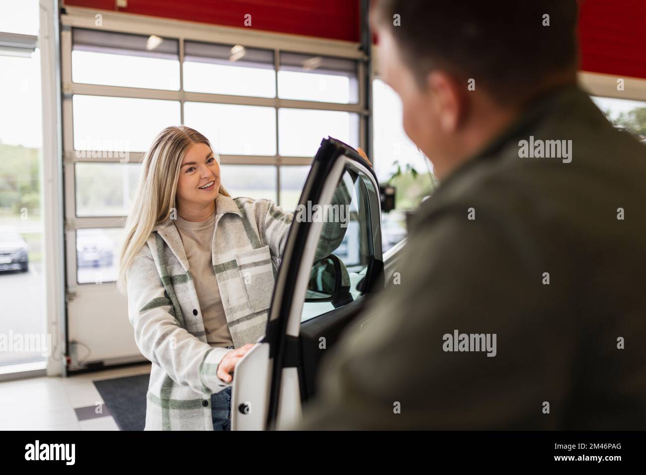 Donna nell'ufficio della concessionaria auto Foto Stock