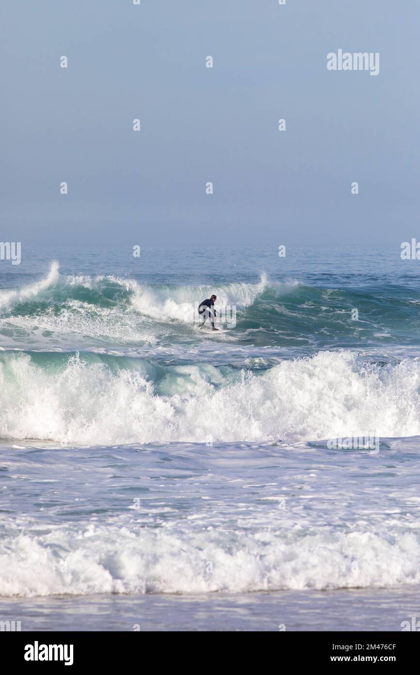 Europa, Portogallo, Regione Centro, Ferrel, Praia da Almagreira, Surfista in sella a un'onda sull'Oceano Atlantico Foto Stock