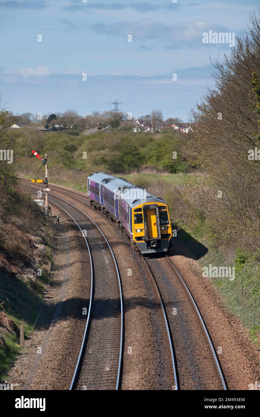 Treno di classe 158 nord 158755 passando Poulton le Fylde con semaforo casa e segnali distanti Foto Stock