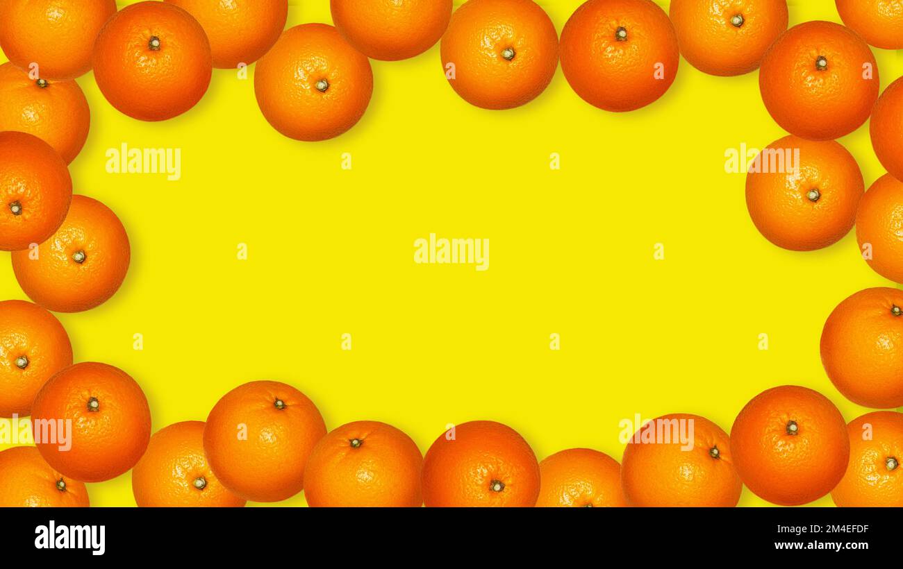 Sfondo con arance. Molte arance su sfondo giallo. Banner. Foto Stock