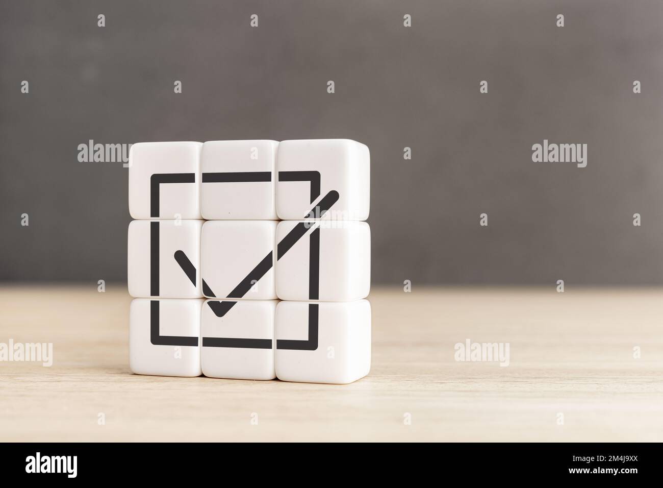 Raggiungimento degli obiettivi e successo aziendale. Completamento dell'attività. Blocchi di cubo con l'icona del segno di spunta. Spazio di copia Foto Stock