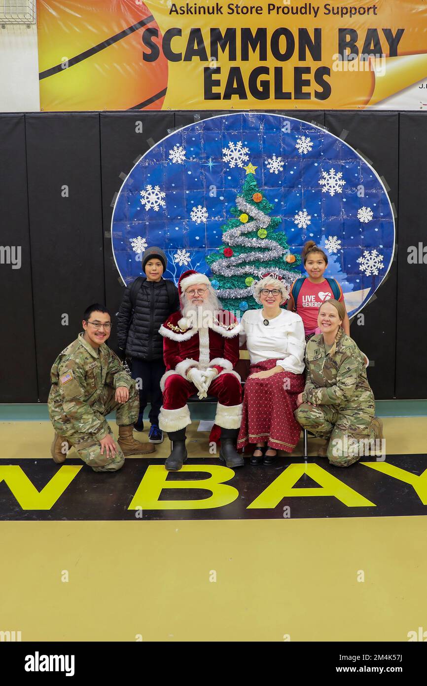 Scammon Bay, Stati Uniti d'America. 16 Novembre 2022. Babbo Natale e Mrs Claus posano con i membri della Guardia Nazionale aerea dell'Alaska e i bambini durante l'operazione Babbo Natale al centro della comunità di Scammon Bay, 16 novembre 2022 a Scammon Bay, Alaska. Babbo Natale e Mrs Claus con l'aiuto della Guardia Nazionale e dell'Esercito della salvezza, forniscono regali di Natale, libri, forniture scolastiche e omaggi ai giovani delle remote comunità rurali dell'Alaska. Credit: Alaska Air Guard/National Guard/Alamy Live News Foto Stock