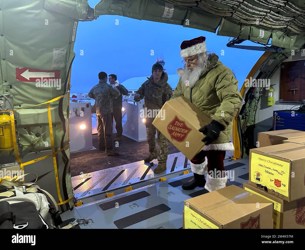 Polo Nord, Stati Uniti d'America. 22 Novembre 2022. Babbo Natale e i suoi elfi scaricano le scatole da un aereo Stratotanker Wing KC-135 168th durante l'operazione Babbo Natale alla base dell'aeronautica di Eielson, 22 novembre 2022 nel Polo Nord, Alaska. Babbo Natale e Mrs Claus con l'aiuto della Guardia Nazionale e dell'Esercito della salvezza, forniscono regali di Natale, libri, forniture scolastiche e omaggi ai giovani delle remote comunità rurali dell'Alaska. Credit: Dana Rosso/National Guard/Alamy Live News Foto Stock