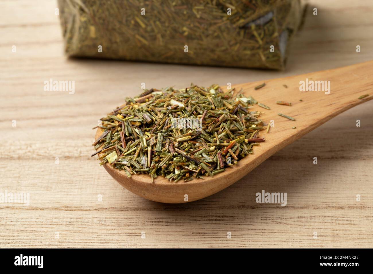 Cucchiaio con foglie di tè verde secco non fermentato sudafricano Rooibos primo piano Foto Stock
