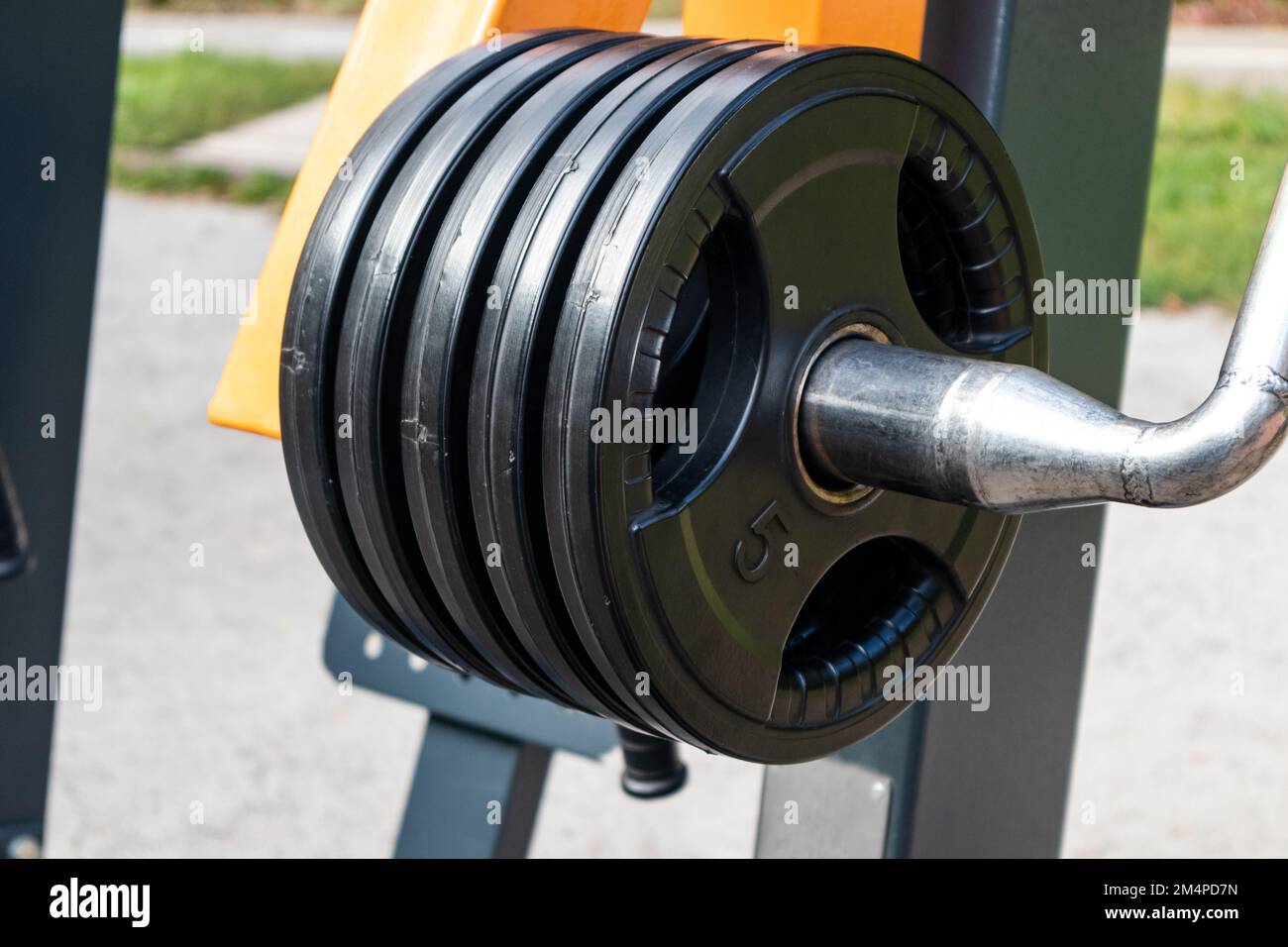 Campo sportivo all'aperto con attrezzature per l'allenamento dei pesi. Primo piano con cinque chilogrammi di peso Foto Stock Campo sportivo all'aperto con attrezzature per l'allenamento dei pesi. Primo piano con cinque chilogrammi di peso Foto Stock