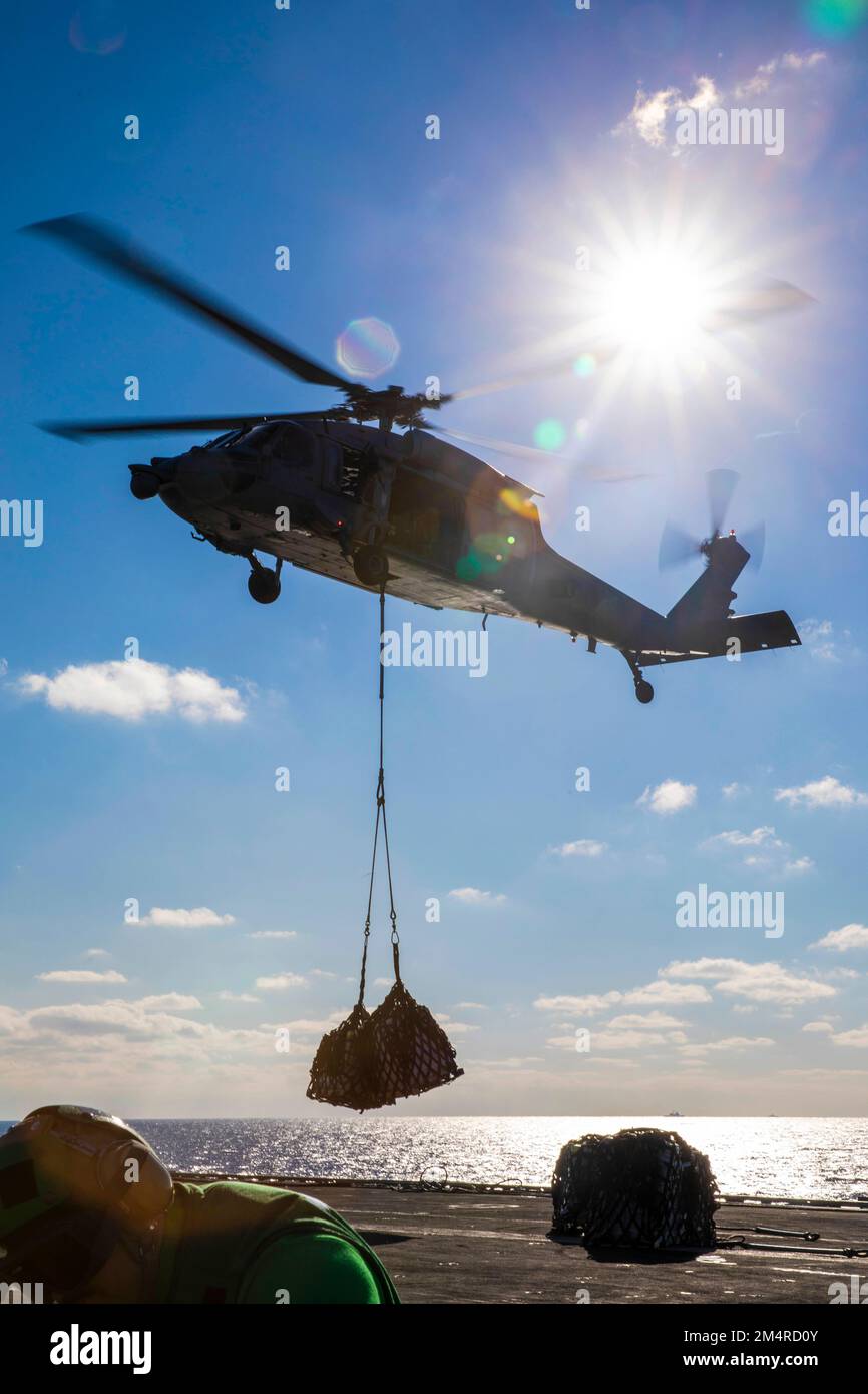 221219-N-UI066-1308 MARE ADRIATICO (19 dicembre 2022) un elicottero MH-60s 8 Nighthawk, attaccato a Helicopter Sea Combat Squadron (HSC) 5, consegna merci alla portaerei di classe Nimitz USS George H. W. Bush (CVN 77), durante un rifornimento in mare con la nave di supporto rapido al combattimento USNS (T-A10 dicembre 19, 2022). The George H.W. Bush Carrier Strike Group è in fase di implementazione pianificata negli Stati Uniti Naval Forces Europe area of Operations, impiegato dagli Stati Uniti Sesta flotta per difendere gli interessi degli Stati Uniti, alleati e partner. Carrier Air Wing (CVW) 7 è la componente offensiva dell'aria e dell'attacco Foto Stock