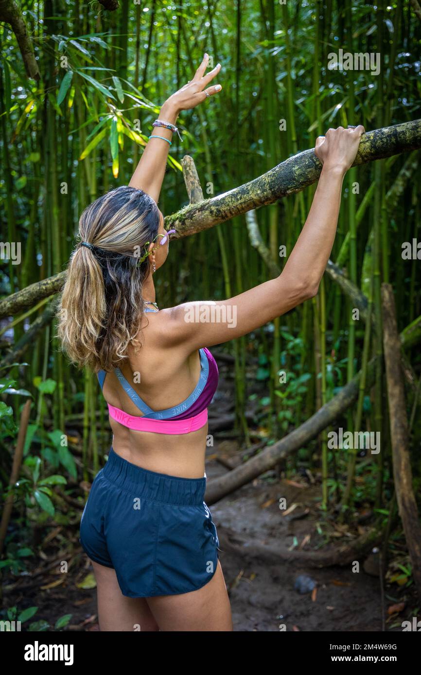 Ritratto di una giovane donna caucasica in un tour escursionistico in una foresta sull'isola o'ahu, Hawaii Foto Stock