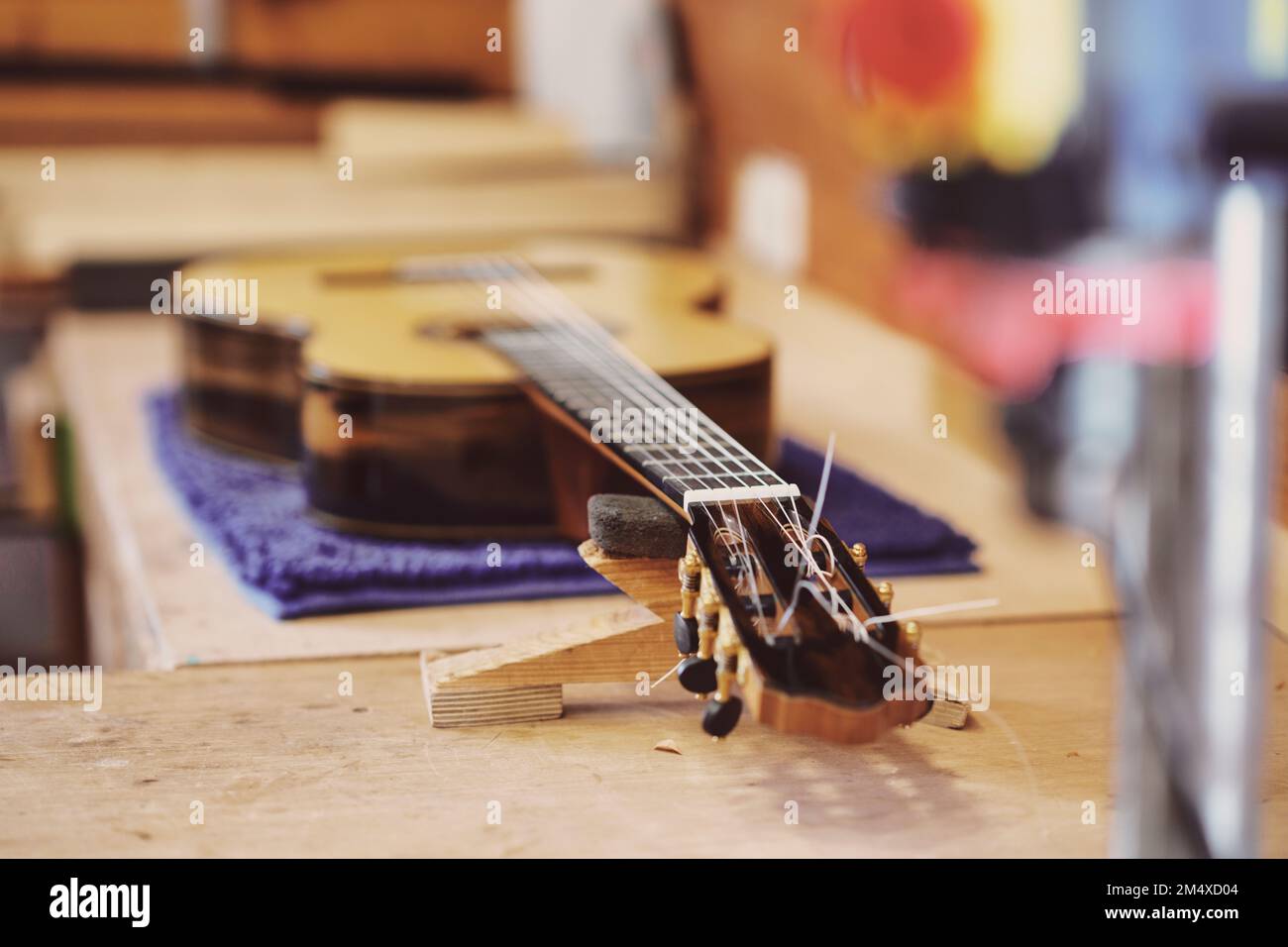 Chitarra sul banco di lavoro in officina Foto Stock