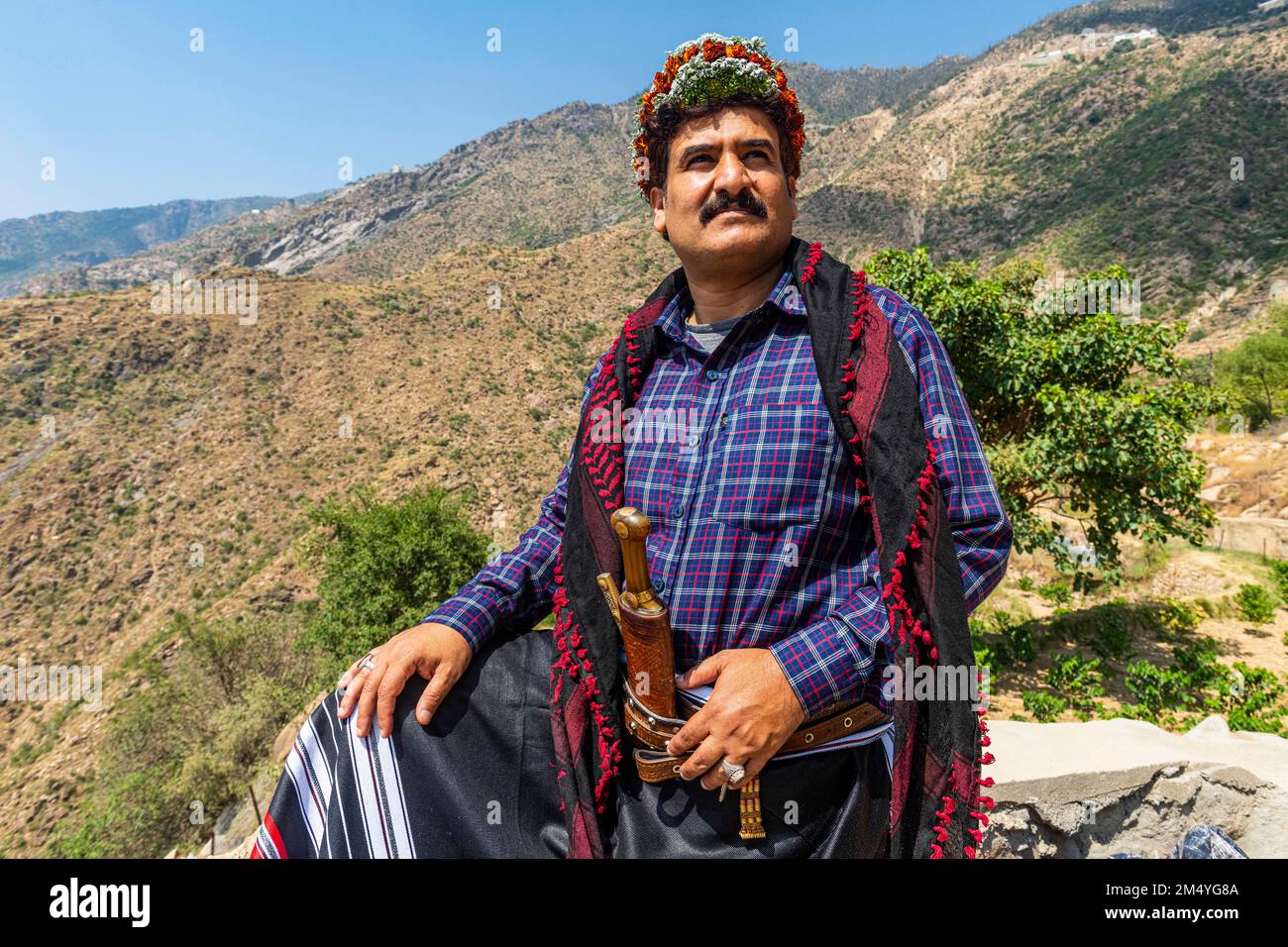 Uomo tradizionale vestito della tribù Qahtani Flower Men nelle piante da caffè, montagne ASiR, Regno dell'Arabia Saudita Foto Stock