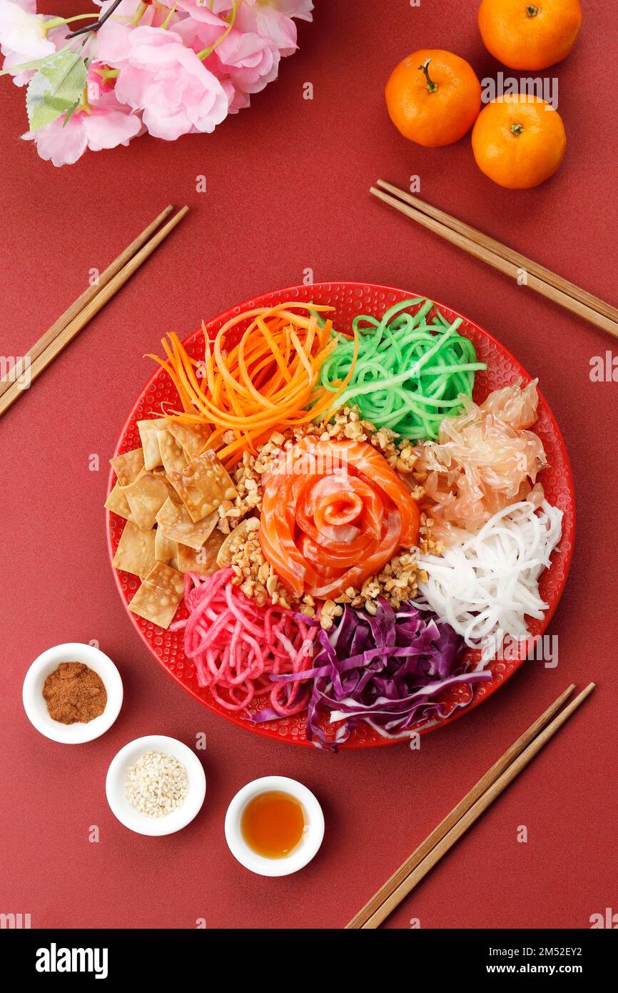 Sana e deliziosa insalata di Yee Sang fatta in casa. Prosci di prosperità colorato, mangiato crudo con speziato, dolce e acidulo condimento Foto Stock