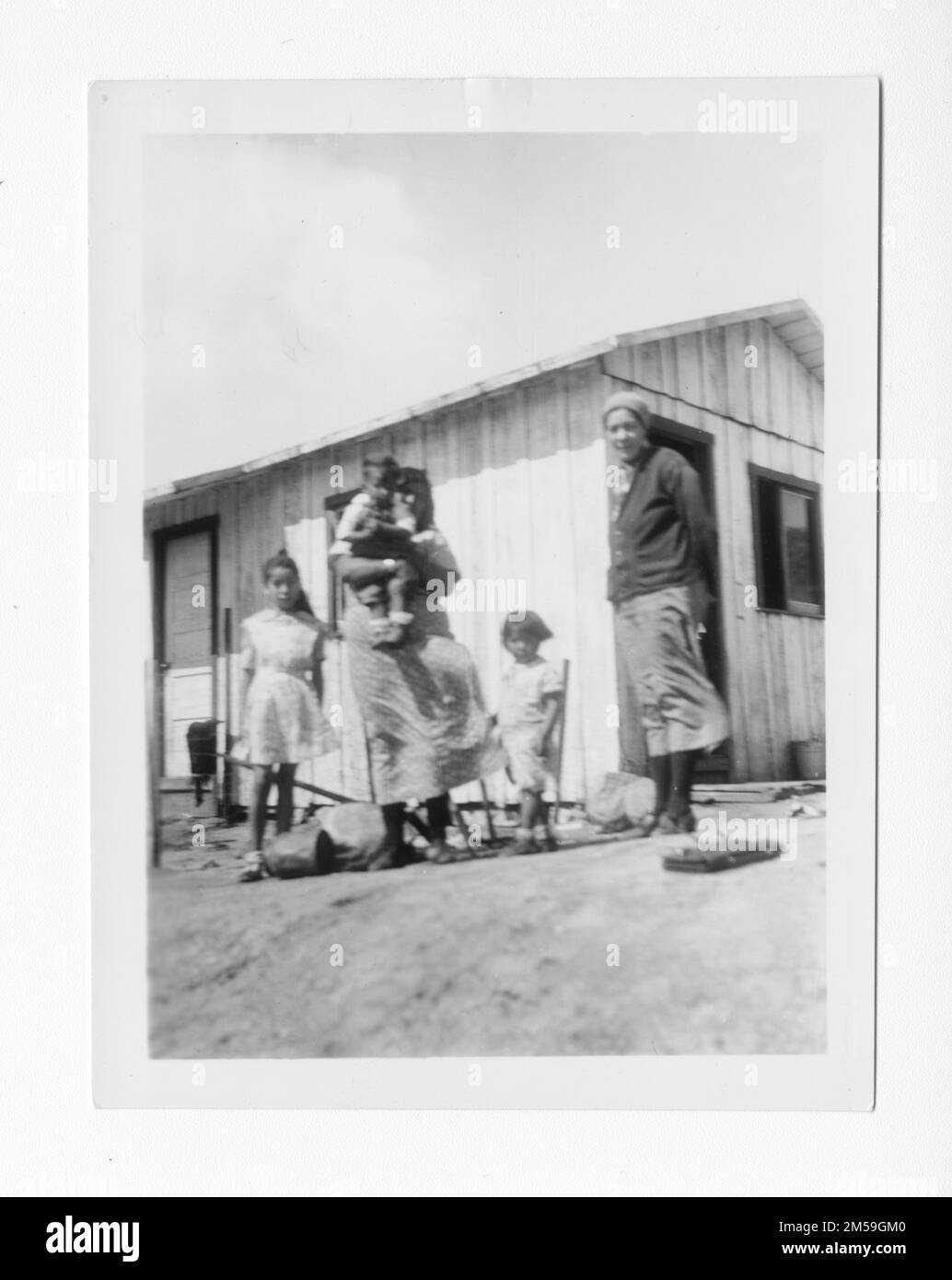 Didascalia originale: 'Louise e Orosco Long hanno 5 figli e la nonna Marcella Osway. Bisogno di un'altra stanza molto male.'. 1936 - 1942. Regione del Pacifico (Riverside, CA). Stampa fotografica. Dipartimento dell'interno. Ufficio degli affari indiani. Agenzia di missione. 11/15/1920-6/17/1946. Fotografie Foto Stock