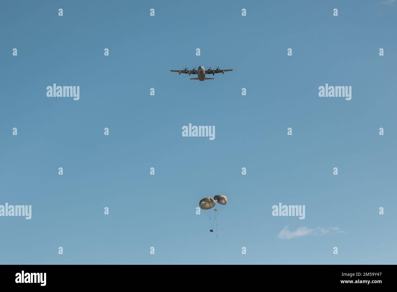 NEGLI STATI UNITI Marine Corps KC-130J Aircraft assegnato a Marine Aerial Refueler Transport Squadron (VMGR) 152, airdrops equipment a sostegno di Jungle Warfare esercizio 22 su Isola di Shima, Giappone, 15 febbraio 2022. JWX 22 è un'esercitazione di formazione sul campo su larga scala incentrata sull'utilizzo delle capacità integrate di partner congiunti e alleati per rafforzare la consapevolezza, le manovre e gli incendi in tutti i settori in un ambiente marittimo distribuito. Foto Stock