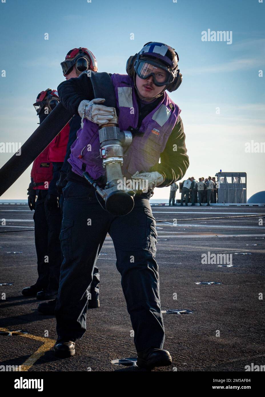 220215-N-SY758-1028 OCEANO ATLANTICO (15 febbraio 2022) Aviation Boatswain’s Mate (rifornimento) Airmen Christopher Godwin rimuove una manichetta di rifornimento dall’area di lancio del ponte di volo sulla portaerei USS George H.W. Bush (CVN 77) durante il TSTA/FEP (Tailored Ship’s Training Availability/Final Evaluation Problem), 15 febbraio 2022. TSTA/FEP è un'evoluzione della formazione multifase progettata per fornire all'equipaggio una solida base di competenza operativa a livello di unità e per migliorare la capacità della nave di autoaddestrarsi. George H.W. Bush fornisce all'autorità nazionale di comando flessibile, saracinevole guerra combattendo capabil Foto Stock