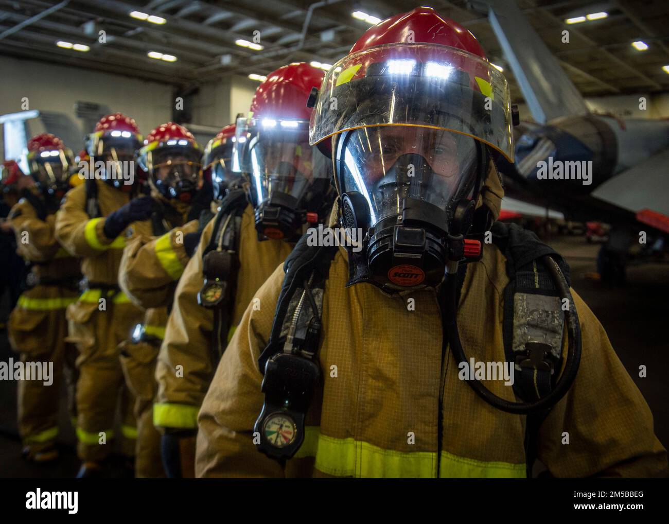 220218-N-SY758-1049 OCEANO ATLANTICO (DAL 18, 2022) marinai assegnati a USS George H.W. Bush (CVN 77) riassemblare dopo aver combattuto un incendio simulato nella baia di hangar durante il Tailored Ship’s Training Availability/Final Evaluation Problem (TSTA/FEP), 18 febbraio 2022. TSTA/FEP è un'evoluzione della formazione multifase progettata per dare all'equipaggio una solida base di competenza operativa a livello di unità e per migliorare la capacità della nave di autoaddestrarsi. George H.W. Bush fornisce all'autorità di comando nazionale capacità di lotta contro la guerra flessibile e personalizzabile attraverso il gruppo di sciopero del vettore che mantiene gli stabili marittimi Foto Stock