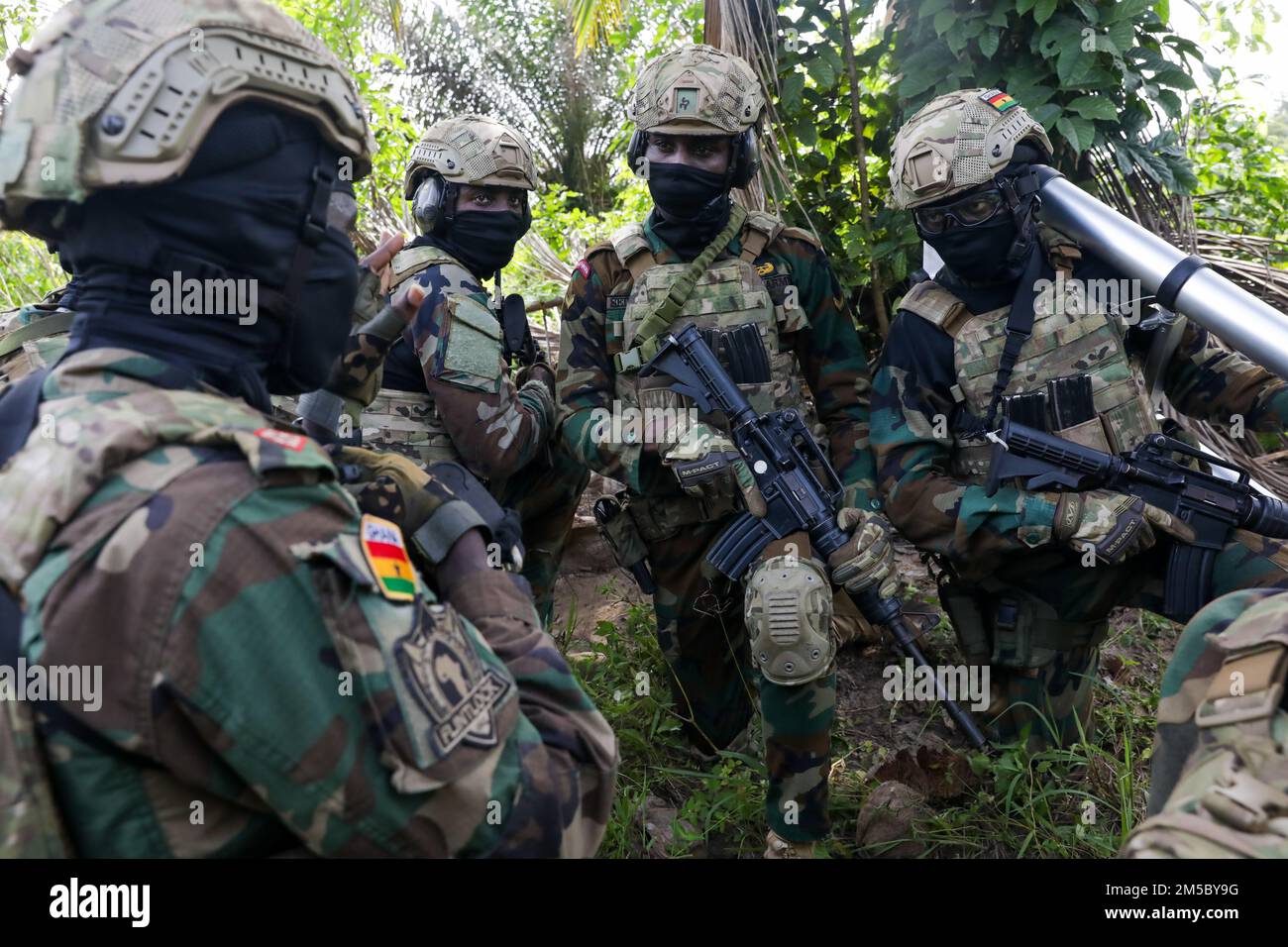 Un comandante delle forze speciali del Ghana consiglia i suoi soldati mentre pattugliava durante Flintlock 2022, in Côte d'Avorio, 26 febbraio 2022. Flintlock è un esercizio multinazionale che consiste in 11 nazioni che si allenano in Côte d'Avorio. Flintlock aiuta a rafforzare la capacità degli alleati e dei partner di contrastare l'estremismo violento e di fornire sicurezza al loro popolo. Foto Stock