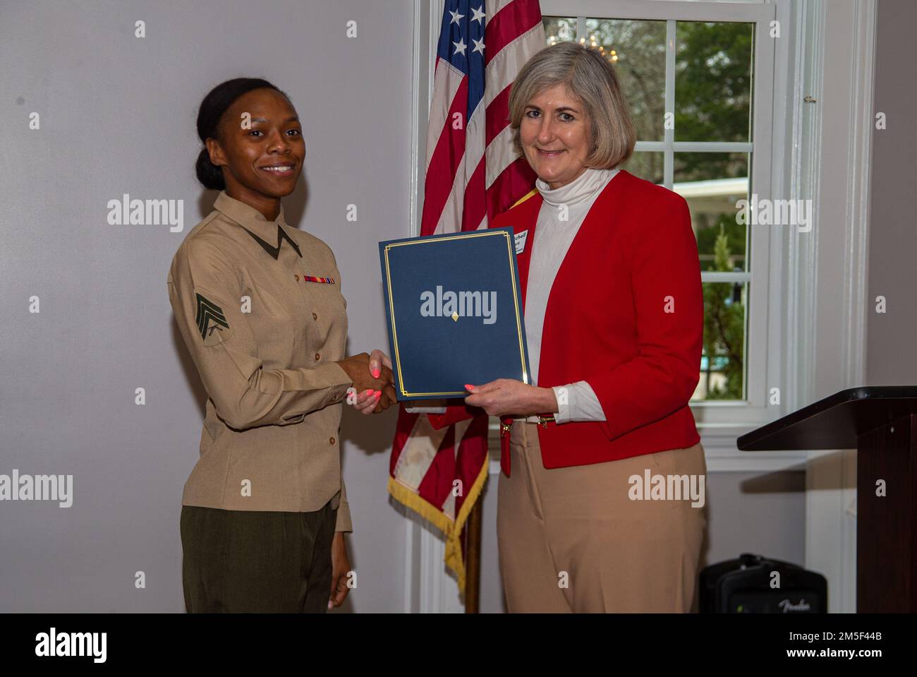 Etteinne “ET” Mitchell, commissario del Consiglio dei Commissari della contea di Craven, presenta gli Stati Uniti Sandra Accilien, specialista amministrativo assegnato a Marine Aviation Logistics Squadron 14, con un premio alla persona di servizio del quartiere al New Bern Golf and Country Club, New Bern, North Carolina, 10 marzo 2022. Accilien è stata riconosciuta dalla Nuova Alleanza militare di Berna per il suo impatto positivo sulla comunità locale. Foto Stock