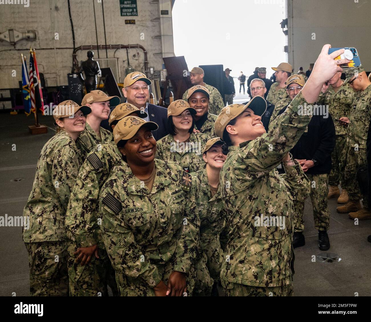 NORFOLK, Virginia (10 marzo 2022) — il Segretario della Marina Carlos del Toro si presenta per una foto di gruppo con marinai assegnati all'incrociatore missilistico guidato di classe Ticonderoga USS Gettysburg (CG 64) a seguito di una chiamata a tutte le mani a bordo di USS Gerald R. Ford (CVN 78) 10 marzo 2022. Il Segretario del Toro è a Norfolk per il centenario delle portaerei della Marina e per condurre una tavola rotonda con le marinai senior durante il mese della Storia delle Donne. Foto Stock
