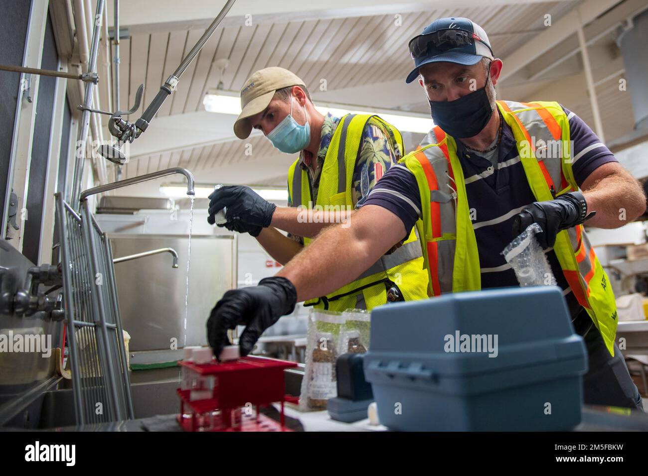 AIEA, Hawaii (11 marzo 2022) ben Joy (a sinistra) e Chris Hayden (a destra), appaltatori del Naval Facilities Engineering Systems Command, raccolgono campioni d'acqua presso la Red Hill Elementary School come parte di un piano approvato interagenzia per il monitoraggio a lungo termine dell'acqua potabile. Gli Stati Uniti Navy sta lavorando a stretto contatto con il Dipartimento della Salute delle Hawaii, Stati Uniti Environmental Protection Agency e gli Stati Uniti Esercito per ripristinare l'acqua potabile sicura alle comunità abitative di Joint base Pearl Harbor-Hickam attraverso il campionamento e il lavaggio, e il recupero del pozzo di Red Hill. Per informazioni dettagliate, visitare il sito Web www.navy.mil/jointbas Foto Stock
