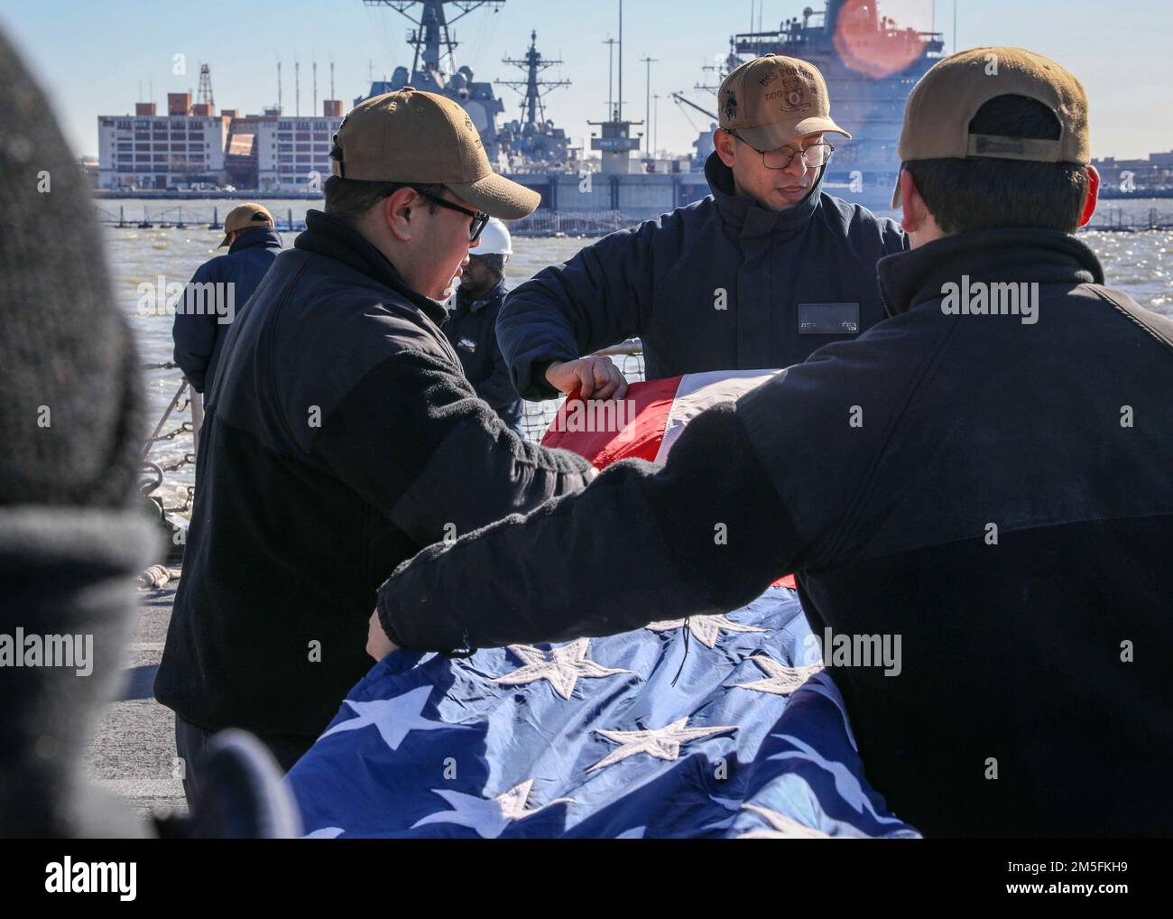 NORFOLK, Virginia (13 marzo 2022) – i marinai piegano la firma dopo essere saliti a bordo del cacciatorpediniere missilistico guidato di classe Arleigh Burke USS Porter (DDG 78), marzo 13. USS Porter, schierato in futuro a Rota, Spagna, sta attualmente partecipando all'esercizio della Task Force nell'area operativa della flotta degli Stati Uniti 2nd. TFEX funge da esercizio di certificazione per l'implementazione indipendente di navi ed è progettato per testare la preparazione e le prestazioni della missione in operazioni integrate. Foto Stock