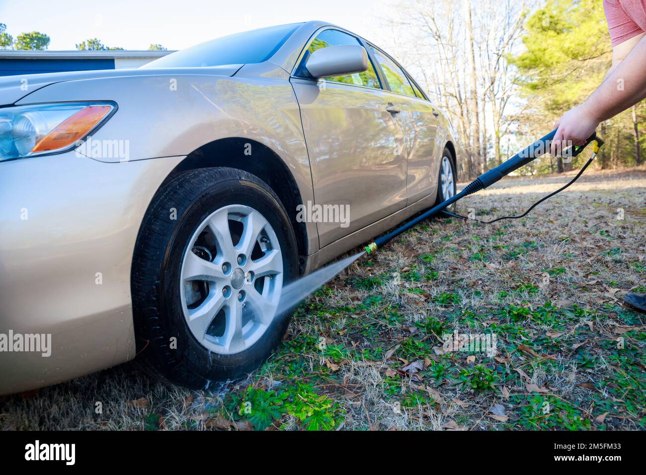 Durante il lavaggio, utilizzare uno spruzzatore per autolavaggio con acqua Foto Stock