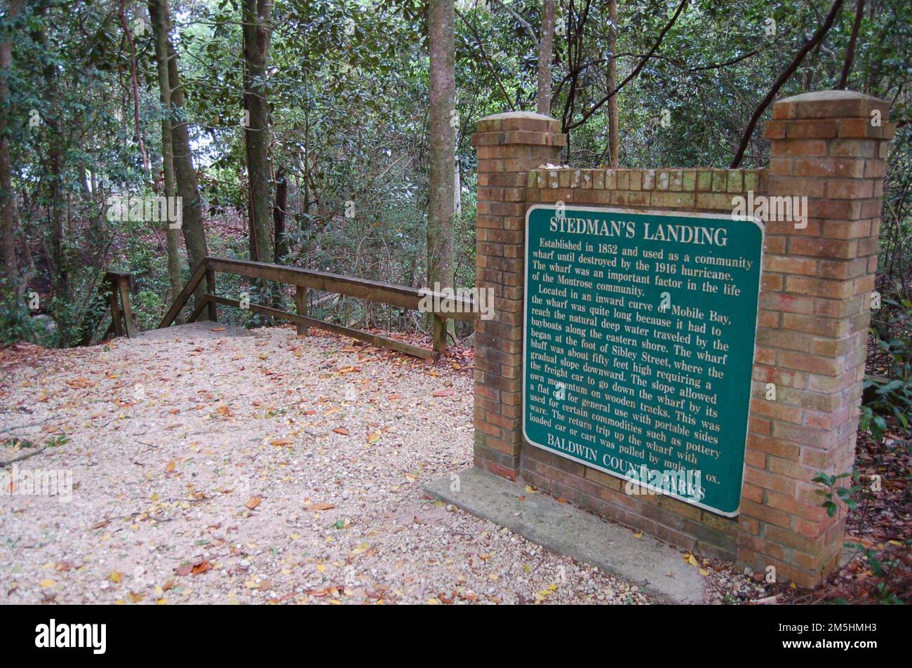 Alabama's Coastal Connection - passeggiata sul lungomare di Steadman's Landing. Un indicatore storico in cima alla passerella per la spiaggia di Steadman's Landing, parte del Baldwin County Parks System recita: Fondato nel 1852 e utilizzato come banchina della comunità fino a quando distrutto dall'uragano del 1916. Il pontile era un fattore importante nella vita della comunità Montrose. Situato in una curva interna di Mobile Bay, il molo era abbastanza lungo perché doveva raggiungere le acque profonde naturali percorse dalle barche della baia lungo la costa orientale. Il pontile iniziò ai piedi di Sibley Street, dove la scogliera di circa cinquanta piedi h. Foto Stock