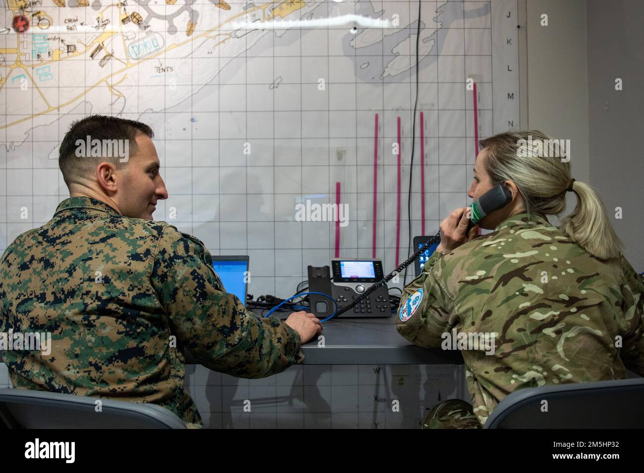 STATI UNITI Tim Harpe, a sinistra, e la Royal Navy Lt. Natalie Grainger discutono le operazioni presso la base dell'aeronautica norvegese Bodø, Norvegia, 18 marzo 2022, come parte dell'esercizio Cold Response 2022. Harpe è l'ufficiale responsabile del centro di comando aereo tattico assegnato a 2D Marine Aircraft Wing (MAW), II Marine Expeditionary Force, e Grainger è un ufficiale di collegamento assegnato a 2D MAW. Exercise Cold Response '22 è un esercizio biennale di preparazione e difesa nazionale norvegese che si svolge in tutta la Norvegia, con la partecipazione di ciascuno dei suoi servizi militari, nonché da 26 Nort aggiuntivi Foto Stock