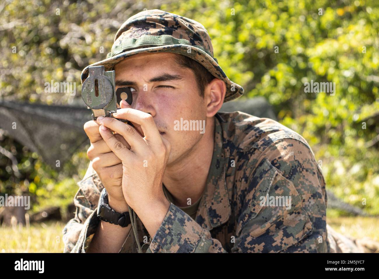 STATI UNITI Carson Kress, un missileman anticarro con il Battaglione Landing Team 1/5, 31st Marine Expeditionary Unit (MEU), guarda attraverso una bussola durante le esercitazioni antincendio a Barrigada, Guam, 21 marzo 2022. Esercizio Noble Arashi fa parte della Nobile Serie di esercizi 31st dell'MEU che vengono utilizzati per convalidare o invalidare la Famiglia di concetti Navali, sviluppare tecniche e procedure per l'impiego di beni dell'MEU a sostegno della negazione del mare e della manovra della flotta, e informare il futuro progetto di forza e gli sforzi di sperimentazione. Il 31st MEU opera a bordo delle navi dell'America Expeditione Foto Stock
