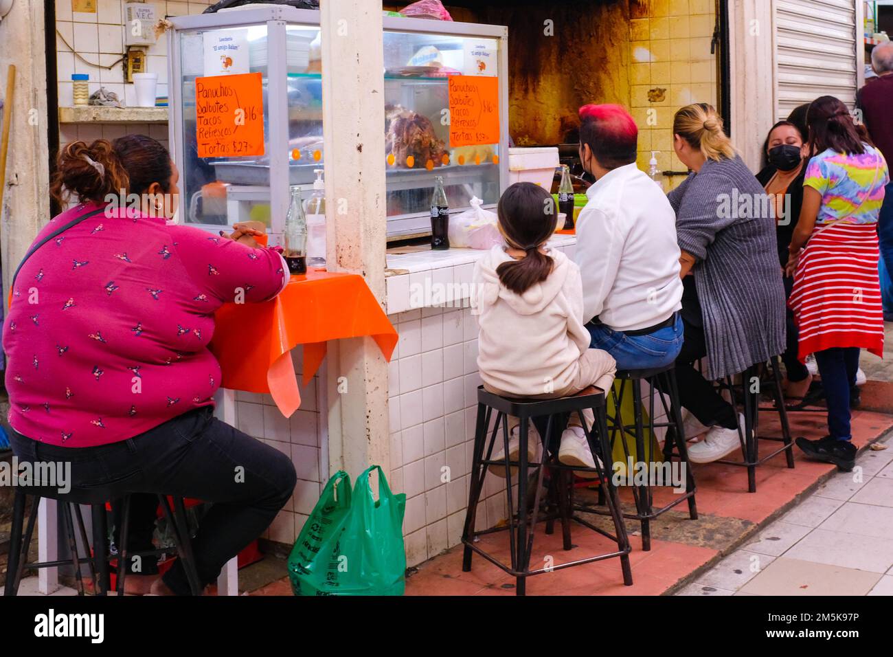Le persone che pranzano in uno snack-bar al mercato Lucas de Galvez nel centro di Merida, Yucatan, Messico Foto Stock