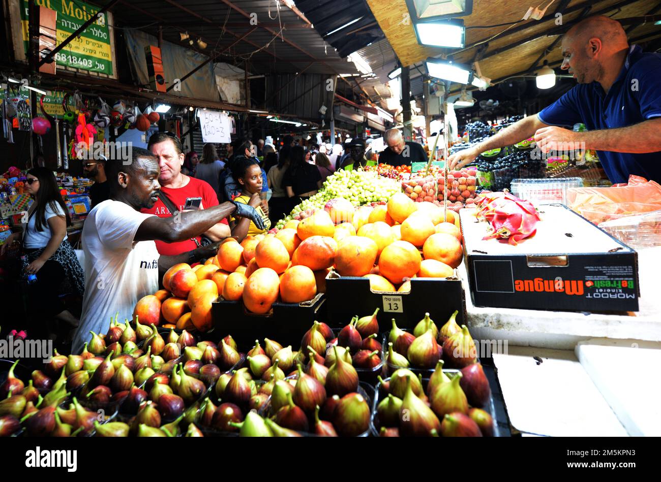 Un venditore di frutta nel vivace mercato Carmel di Tel-Aviv, Israele. Foto Stock