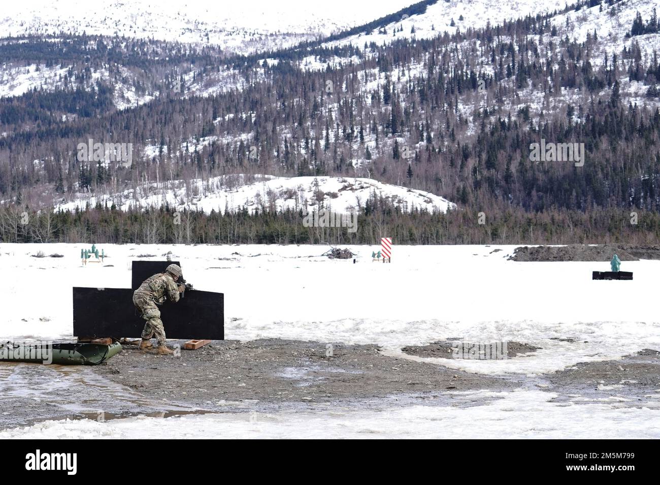 Un paracadutista assegnato a Dog Company, 3rd battaglione, 509th reggimento di fanteria paracadute, 4th squadra di combattimento della Brigata di fanteria (Airborne), 25th divisione di fanteria, Stati Uniti Army Alaska, partecipa all'allenamento antincendio presso la base militare Elmendorf-Richardson, Alaska, 24 marzo 2022. I soldati della Dog Company sono stati valutati in base al rapido coinvolgimento degli obiettivi di fuoco vivo, evacuando in sicurezza un incidente simulato sul campo di battaglia tramite una lettiera improvvisata SKED e rompendo il contatto su pericolosi terreni fangosi e ghiacciati. (STATI UNITI Air Force foto/Justin Connaher) Foto Stock