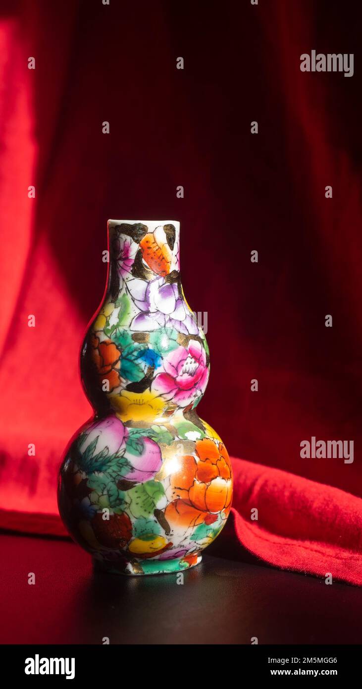 Ceramica cinese in un'asta contro uno sfondo rosso. Sfondo Capodanno cinese Foto Stock