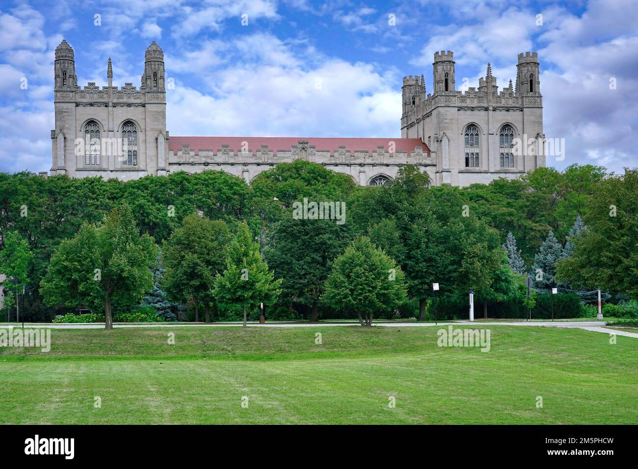 Campus dell'Università di Chicago con edificio gotico visto sopra gli alberi dall'altra parte del parco Midway Plaisance Foto Stock