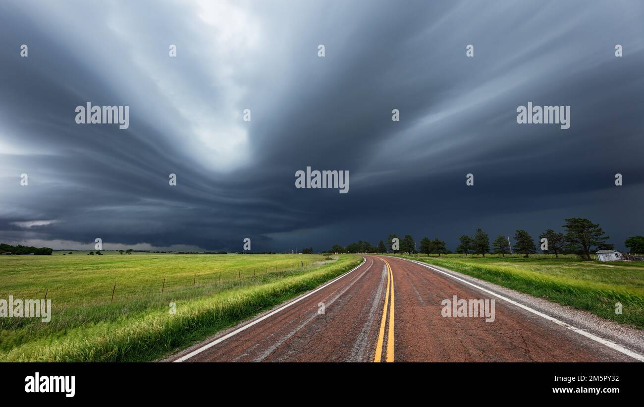 Strada che porta a una nuvola di tempeste di supercelle Foto Stock