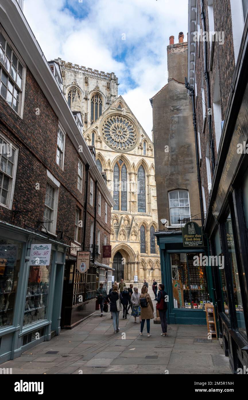 Una stretta strada pedonale-libera-Minster Gate che conduce verso York Minster nella città vecchia di York in Yorkshire, Gran Bretagna Foto Stock