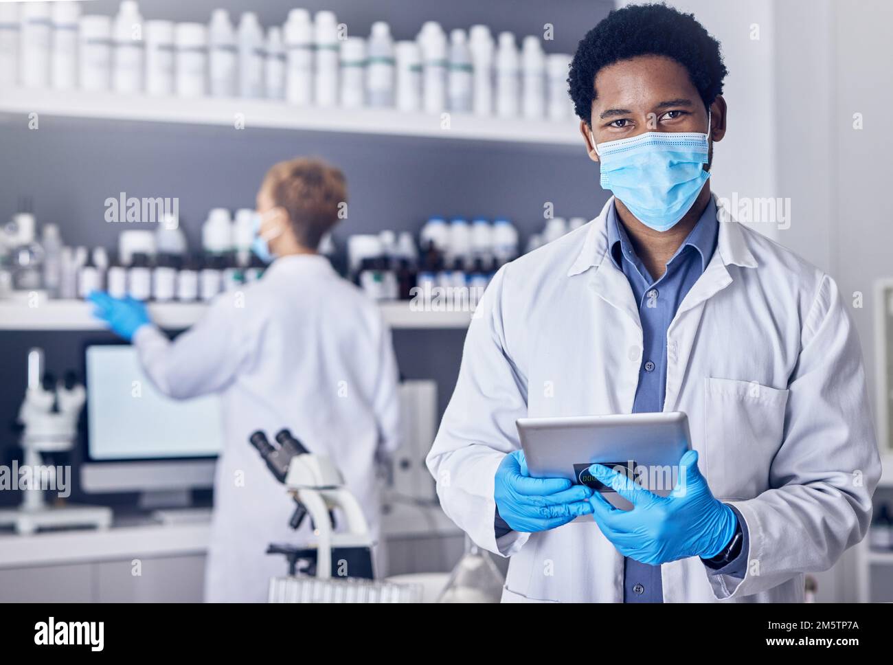 Ritratto, scienza e uomo nero con maschera, compressa e laboratorio per il vaccino, cura o assistenza sanitaria. Professionista medico, copertura viso o nigeriano maschio in Foto Stock