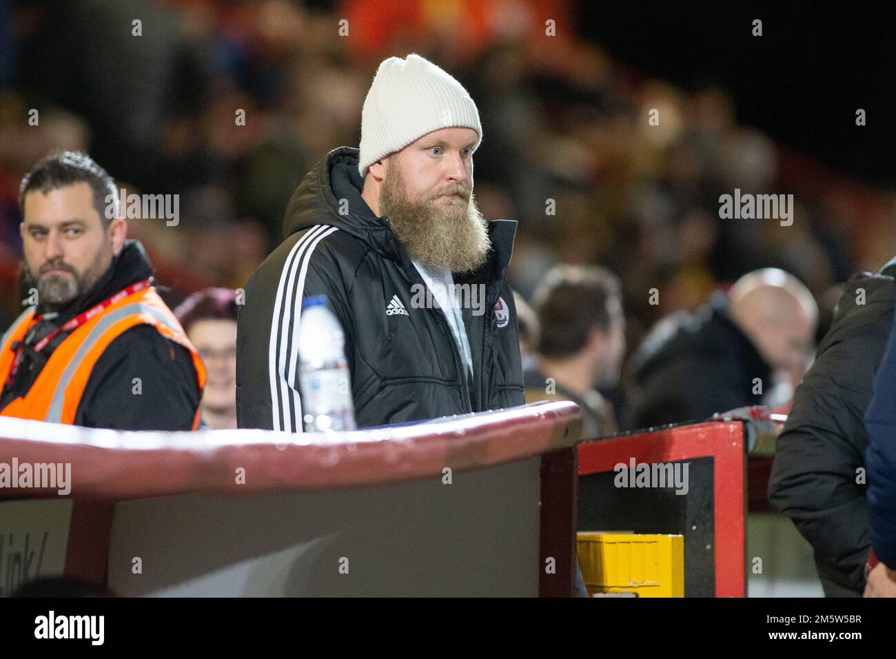 Preston Johnson, co-presidente del Crawley Town FC che guarda la sua squadra dal dugout durante la partita. Foto Stock