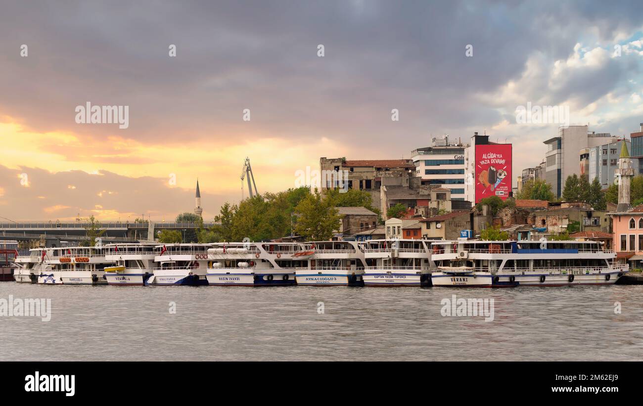 Istanbul, Turchia - 25 agosto 2022: Traghetti attraccati vicino al Ponte della metropolitana del Corno d'Oro, o Ponte Halico, al tramonto in una giornata di sole estivo Foto Stock