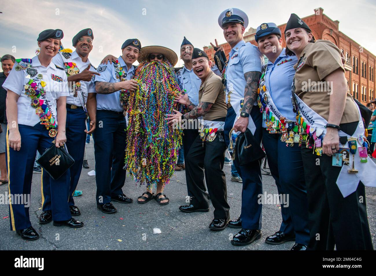 Gli ambasciatori militari della base comune di San Antonio si fermano per scattare una foto con un partecipante locale alla fiesta durante la cerimonia di apertura della Fiesta, il 31 marzo 2022, presso l'Hemisfair Park di San Antonio, Texas. Fiesta Fiesta segna ufficialmente l'inizio della celebrazione annuale di 11 giorni, con sfilate, mostre, musica, intrattenimento e divertimento per tutta la famiglia - tutte a beneficio delle cause locali e non-profit. Foto Stock