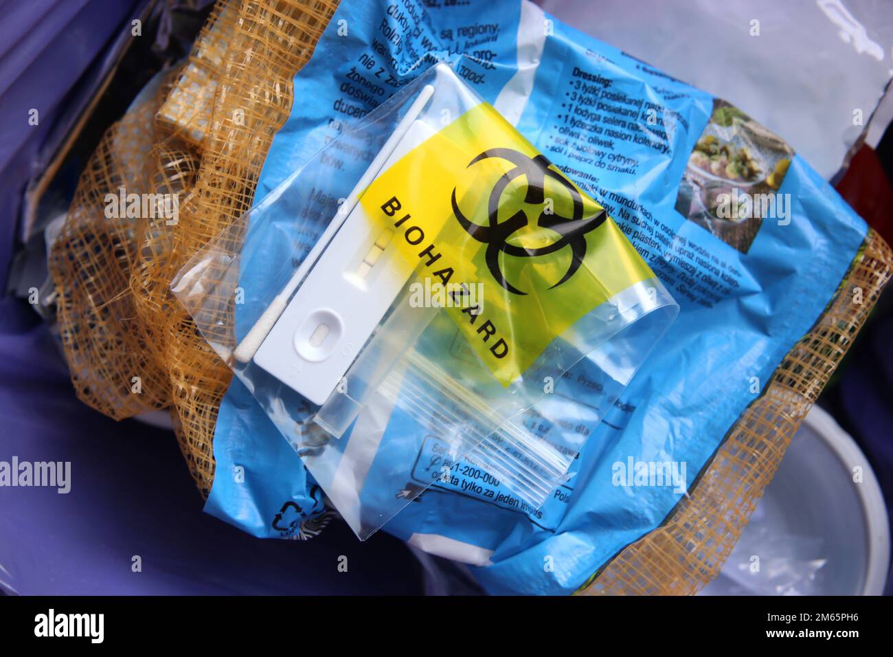 Kit di test SARS Covid Antigen utilizzato nel sacchetto monouso per rifiuti a rischio biologico, inserito in un contenitore per rifiuti. Foto Stock
