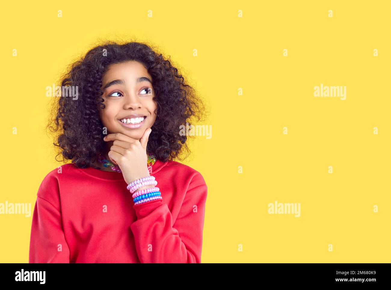Sorridente ragazza biracial guardare a buon affare da parte Foto Stock