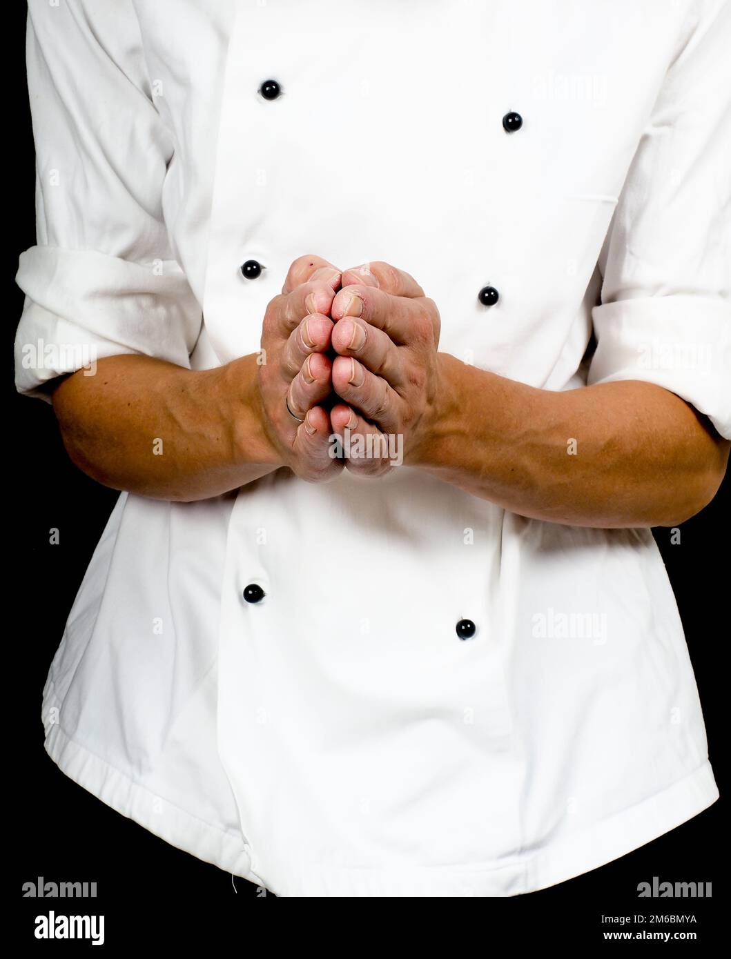 Chef professionale con un gesto di mano verso, indossa una giacca di cuochi Foto Stock