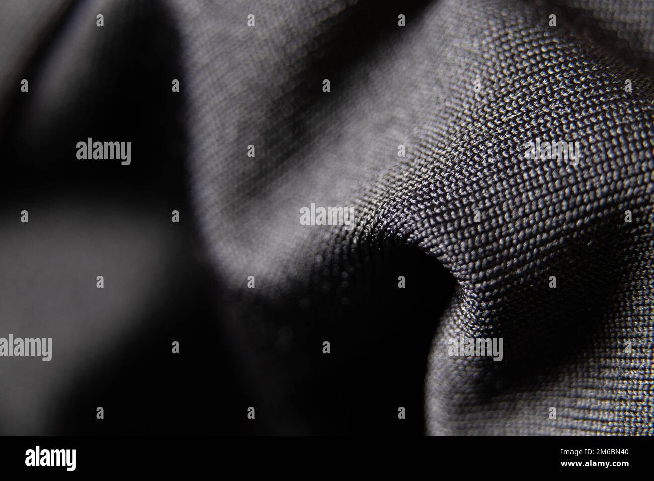 tessuto nero stropicciato come primo piano dello sfondo Foto Stock